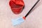 mop cleans linoleum flooring near red bucket
