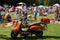 A moped and many people on the music event in the park.