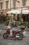 Moped parked on street in front of cafe in Trastevere, Rome, Italy