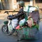 Moped rider Ho Chi Minh City or Saigon, Vietnam. Motorbike driver transporting goods and living hen on motorbike.