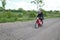 A Moped rider riding a scooter on a country road