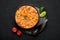 Moqueca with Fish and Shrimps in black bowl on dark slate table top. Brazilian sea food curry dish