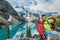 Moraine lake Couple tourists taking selfie picture on Canada travel hike using phone. Young hikers happy using phone on