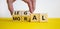Moral or legal symbol. Businessman hand turns wooden cubes and changes the word `moral` to `legal` on a beautiful yellow table