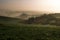 Moravian Tuscany, near Kyjov. Beautiful rolling landscape with morning mist. On the right a small draw with low bushes and trees.