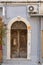 Morbid old wooden door of a grey home