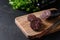 Morcilla blood sausage on wooden tray on black background. Close up.