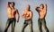 More strength more muscle. Strong men blue sky background. Showing abs biceps. Group muscular men outdoors. Athletic