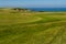 MORFA NEFYN â€“ JUNE 3: Golf course putting green with golfers,