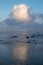 Morgan Bay beach at sundown, Wild Coast, Eastern Cape, South Africa. The clouds are reflected in the water on the beach.