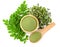 Moringa powder in wooden bowl with  fresh Moringa and dried leaves  on white background,Top view