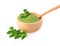 Moringa powder in wooden bowl with  fresh Moringa  leaves  on white background