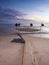 Morning atmosphere at the seaside where local fishing boats docked on the shore.