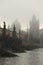 Morning autumn foggy Prague gothic Charles Bridge with Old Town, Czech Republic