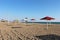 Morning beach, colorful umbrellas on the sand