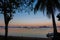 Morning on beach with trees and boats. Sunrise in Palawan island, Philippines. Tropical isles in morning dusk.