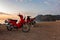 Morning on the beach in the village of Cirali, red scooters stand on the beach., morning scooters ride. . Landscapes of