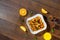 Morning breakfast, corn flakes, raisins, almonds, orange juice, top view, on a dark wooden background, flat lay. The concept of