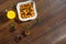 Morning breakfast, corn flakes, raisins, almonds, orange juice, top view, on a dark wooden background, flat lay. The concept of