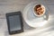 Morning breakfast with a cup of cocoa and an e-book