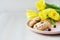 Morning breakfast, oatmeal cookies with cereals and cranberries, yellow tulip flowers