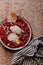 Morning breakfast. Tomato shakshouka with two poached eggs on a plate. Crispy sourdough bread on the side. Coffee in french press