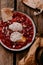 Morning breakfast. Tomato shakshouka with two poached eggs on a plate. Crispy sourdough bread on the side. Coffee in french press