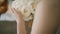 The morning of the bride in a white roses holds in her hands a wedding bouquet of roses. Close up. V3