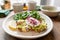 Morning in cafe, oak table. Healthy breakfast with wholemeal bread toast with avocado, poached egg with green salad