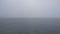 Morning calm water surface with fog, looped video.