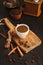 Morning coffee cup and spices on vintage wooden table