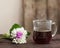 Morning coffee in glass cup with fresh spring flowers bouqet on wood background