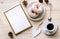 Morning composition with coffee and donuts on a wooden table. Gold frame for the presentation of works or text.