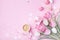 Morning cup of coffee, cake macaron, gift box and spring tulip flowers on pink background. Beautiful breakfast for Women day