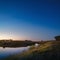 Morning dawn on a starry background sky reflected in the water o