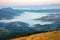 Morning dense fog in the mountainous forest area of the Ukrainian Carpathians. Landscape in nature. Dawn in the mountains