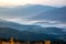 Morning dense fog in the mountainous forest area of the Ukrainian Carpathians. Landscape in nature. Dawn in the mountains