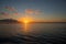 Morning dew sky with orange cloud and sun. Seaside sunrise photo. Vibrant orange sky with sun over sea