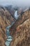 Morning fog lifts above the Lower Falls of the Yellowstone River