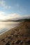 Morning fog over the Chivyrkuisky Bay. Sandy beach with plants of Isatis oblongata in a Snake Bay (Zmeyevaya Bay)