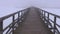 Morning fog on wooden bridge and one walking schoolboy