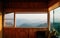 Morning forest and mountain view from wooden cabin living room i