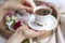 Morning fragrant coffee in a white cup in female hands. Vintage photo