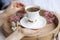 Morning fragrant coffee in a white cup in female hands. Vintage photo.