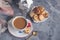 Morning hot chocolate in the original white Cup with a blue button on the background of biscuits. Invigorating Breakfast.