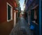 Morning on the island of Burano. Cat in the window. The streets of the old city of Venice. Bright sun. The beauty of the ancient