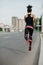 Morning jog on road in city. Muscular girl in sportswear froze in air, jogging