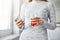 Morning juice refresh mind. Cropped portrait of modern slender woman standing near window, holding glass of juice and