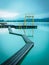 Morning at the lake in Walchsee with jetty and diving tower