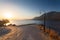 Morning landscape with lamp near viewpoint, mountains and sea.